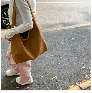 Close-up of caramel brown frosted suede tote bag showing soft texture and large capacity
