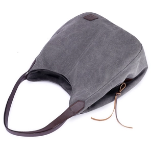 Dark grey canvas tote bag with brown leather handles and a minimalist retro design