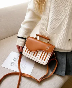 Chic caramel bag with piano key design and metal musical note detail on a sofa