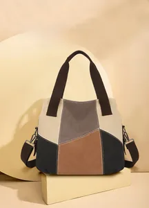 Detail view of the canvas tote bag showing retro color blocking and crossbody metal hooks