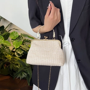Chic beige woven chain crossbody shell bag with gold metallic handle and floral accents