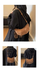 Macro detail of the brown suede half-moon bag featuring vintage tassels and fine stitching