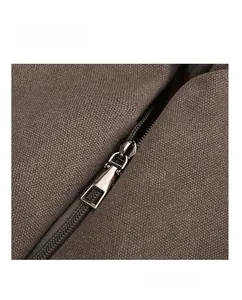Detail of smooth silver metal zipper on vintage brown canvas tote bag with durable teeth