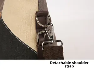 Detail of detachable shoulder strap with silver D-ring and metal clasp on canvas bag