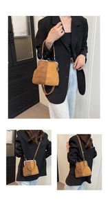 Detail of two-tone suede shell bag with vintage metal clasp and adjustable shoulder strap