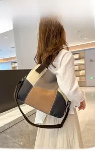 Side view of large color-block canvas tote bag with adjustable shoulder strap and handles