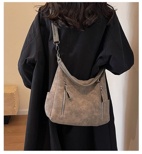 Detailed back view of a retro large-capacity leather hobo bag with dual vertical zippers