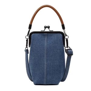 Detail of vintage denim crossbody phone bag with metal clasp and brown leather handle