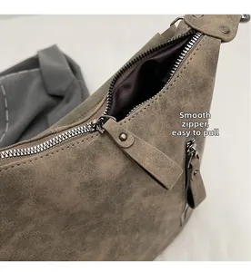 Macro view of smooth metal zipper and matte leather texture on retro shoulder bag