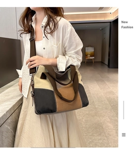 Detail view of large canvas tote bag with contrast stitching and adjustable strap