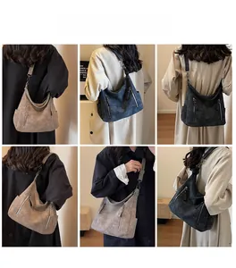 Detail view of large hobo bag with vintage texture and stylish double zippers on model