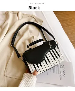 Detail of creative piano crossbody bag with black and white keys and musical note decor