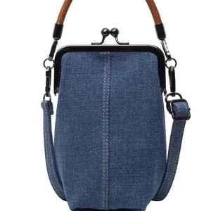 Retro denim crossbody bag with vintage doctor bag closure and dark wooden handle on white background