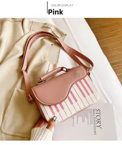 Detailed view of pink piano bag featuring golden music note logo and keyboard flap design