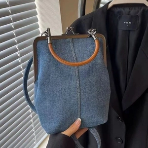 Blue denim crossbody handbag with retro metal clasp and round wooden handle for women