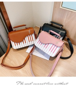 Detail view of stylish piano keyboard purses in brown, pink, and black PU leather colors