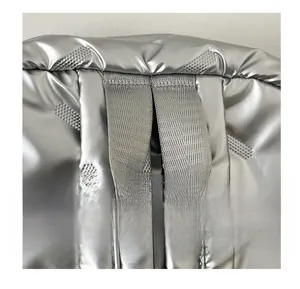 Détail de la poignée tissée et de la texture matelassée argentée sur le sac à dos élégant