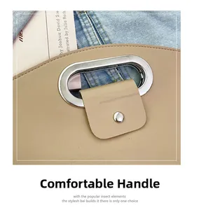 Detail of elegant silver metal handle and beige leather flap on stylish laptop briefcase
