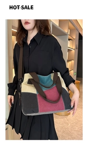 Detailed shot of a color-block canvas tote bag with adjustable shoulder strap for women