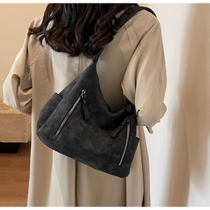 Detail of dark grey suede tote bag with double zippers and comfortable wide shoulder strap