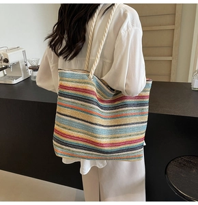 Détail d'un grand sac cabas tissé à rayures colorées avec des anses en corde écrues