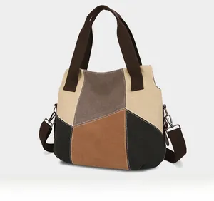 Side view of large canvas tote bag featuring geometric color block patchwork and wide strap