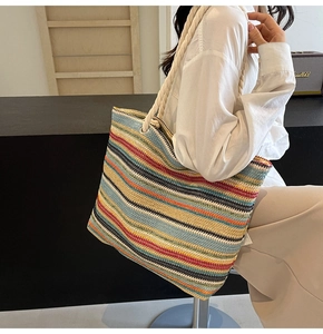 Sac fourre-tout tissé à rayures colorées avec des poignées en corde à l'épaule