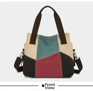 Detailed front view of patchwork canvas tote bag featuring multi-color panels and straps