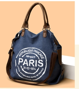 Detail showing high-quality canvas fabric and leather handle on the blue tote bag