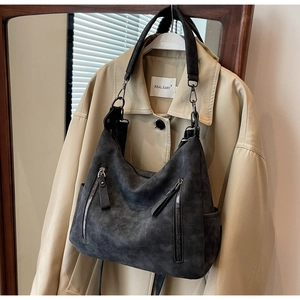 Detail of vintage dark grey large tote bag featuring metallic zippers and matte texture