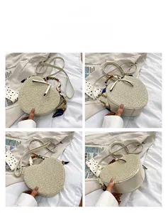 Detail of heart-shaped straw bag featuring floral silk scarf handle and leather strap