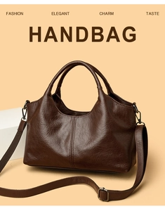 Detail of dark brown leather handbag with pebble texture and adjustable shoulder strap