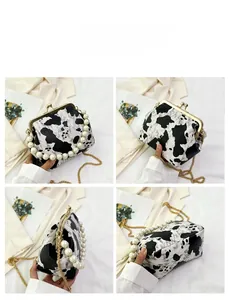 Detailed four-sided view of cow print shell bag with pearl handle and gold chain
