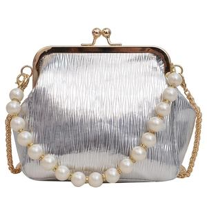 Silver metallic pleated shell bag with oversized pearl handle and gold chain strap