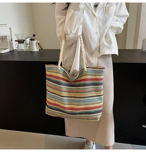 Détail d'un grand sac cabas tissé à rayures colorées avec des anses en corde