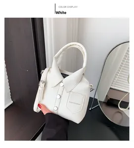 Detail of a white mini handbag featuring a creative shirt-style design with collar and buttons