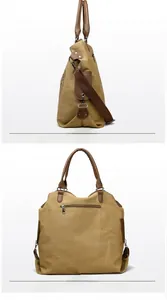 Detail view of khaki canvas tote showing side and back zipper pocket with brown leather accents