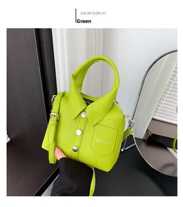 Close-up of green shirt-shaped crossbody bag with silver buttons and fashion text