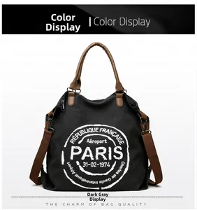 Detail view of large dark gray canvas tote bag with leather handles and Paris print