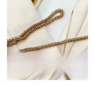 Close-up of premium 18K gold wheat chain strap with polished metal finish and fine texture