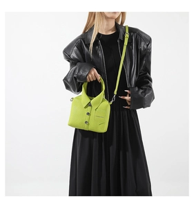 Detail of neon green shirt-style handbag with lapel collar and black button accents
