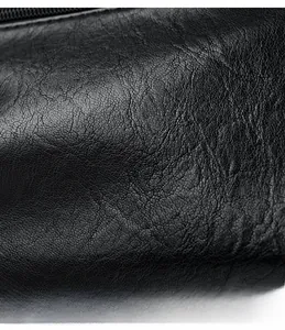 Macro shot of high-quality black lychee grain leather with a premium metal zipper closure