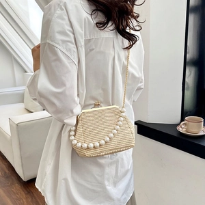Detail of vintage woven shell bag featuring pearl strap and gold chain crossbody