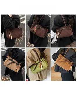 Dettaglio della borsa tote retrò in pelle scamosciata con manici in pelle e ciondolo