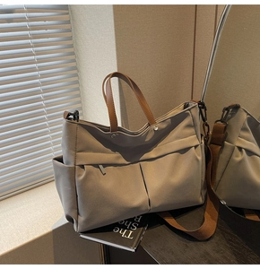 Dettaglio della borsa tote in nylon tortora con manici in pelle e tasche laterali