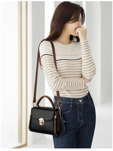 Business style black textured leather handbag with brown handles and gold round lock detail