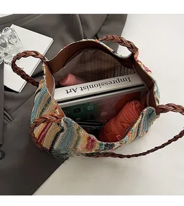 Detailed view of the spacious interior of a striped straw tote bag holding an iPad and books