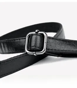 Close-up of black lychee grain leather strap and silver metal buckle on handbag