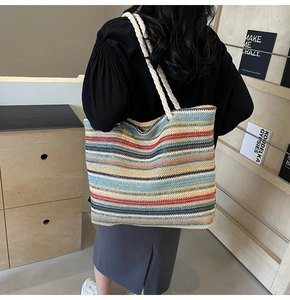 Vue détaillée d'un sac cabas tissé à rayures colorées avec des anses en corde de coton