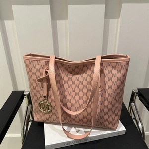 Pink minimalist tote bag with all-over M letter print and gold circular metal charm